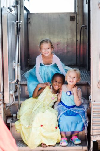 Little girls in princess costume aboard The Princess Flyer